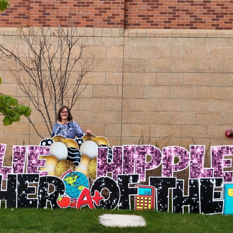 Julie Hippler 2021 Teacher of the Year Julie Hippler standing behind Teacher of the Year Sign at Broadwater Schoold